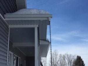 Custom gutters on a roof with snow on it
