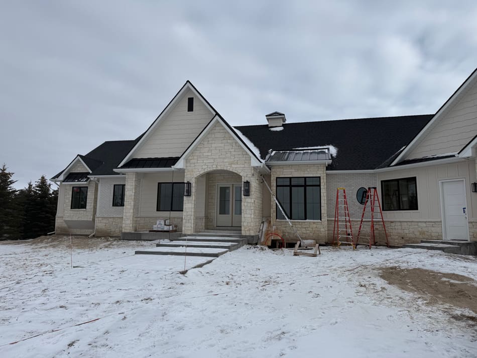 image1 Nice cream colored home with stone and siding in the winter.